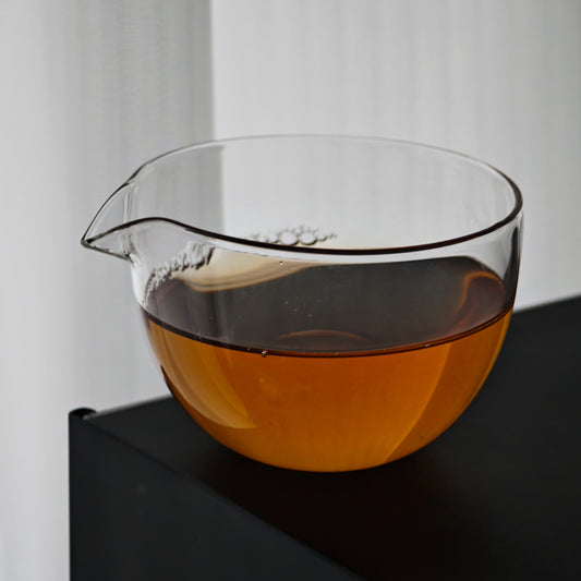 Clear glass tea pitcher filled with amber tea