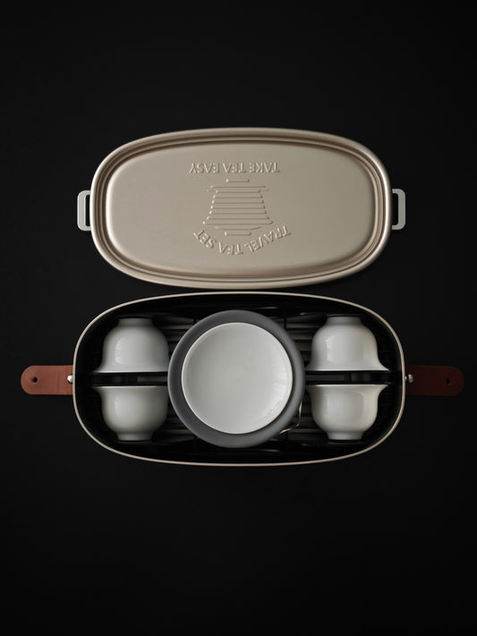 Travel tea set packed in an open aluminum case