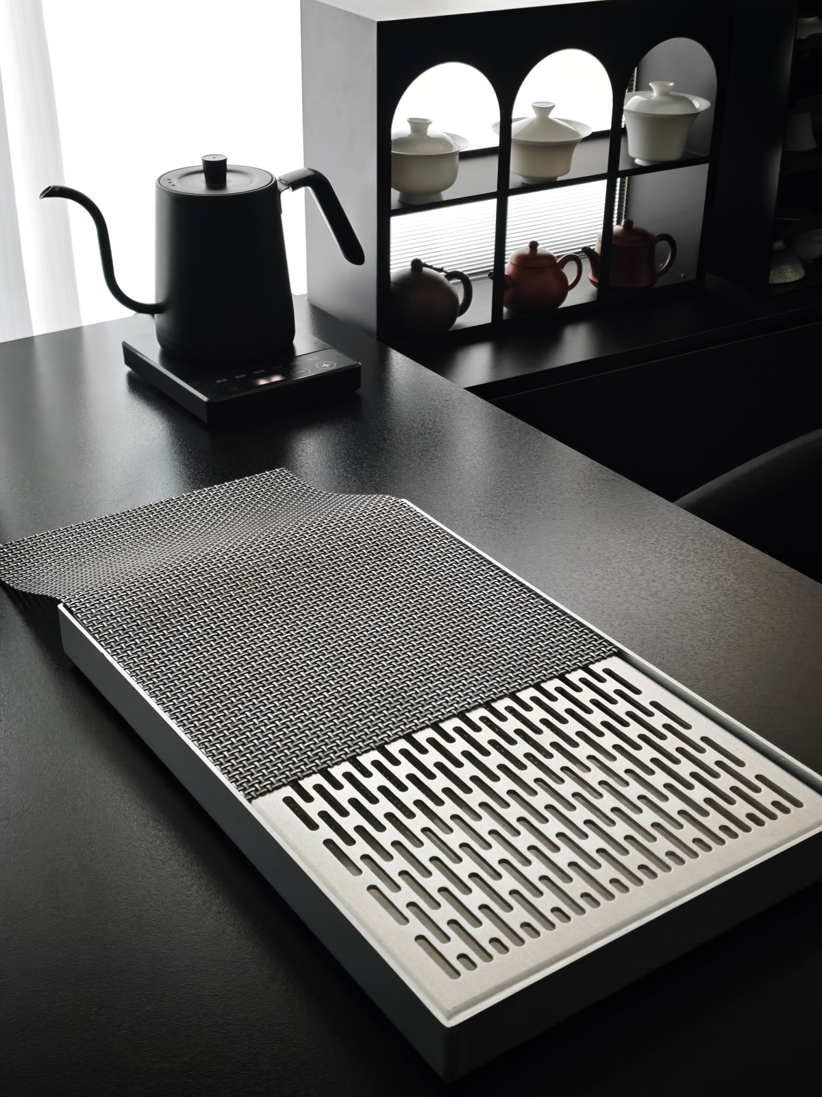 Aluminum tea tray and woven mat on a tea table