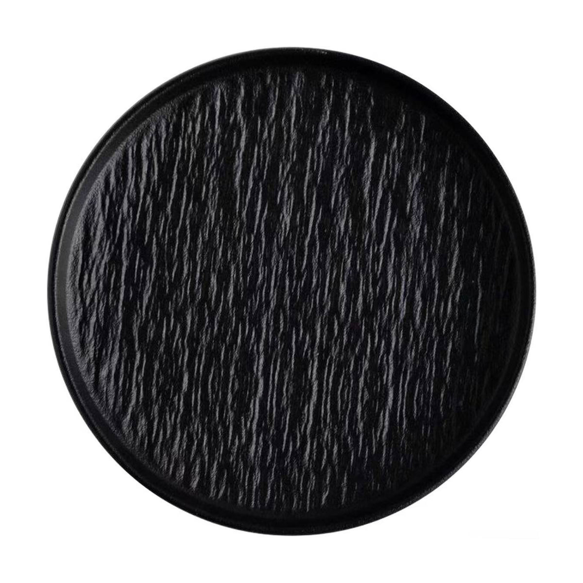 Round black ceramic tray with a textured surface