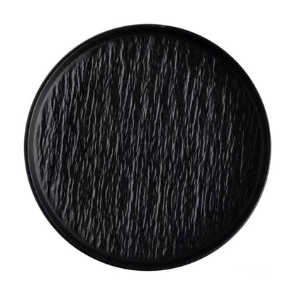 Round black ceramic tray with a textured surface