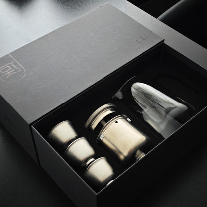 Titanium and glass tea gift set in an open presentation box