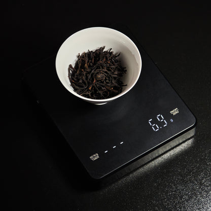 Wider view of tea being weighed on the scale