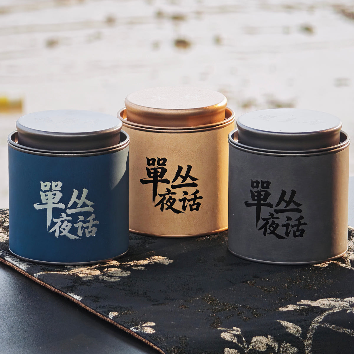 Blue, gold, and gray Phoenix Dancong tea tins