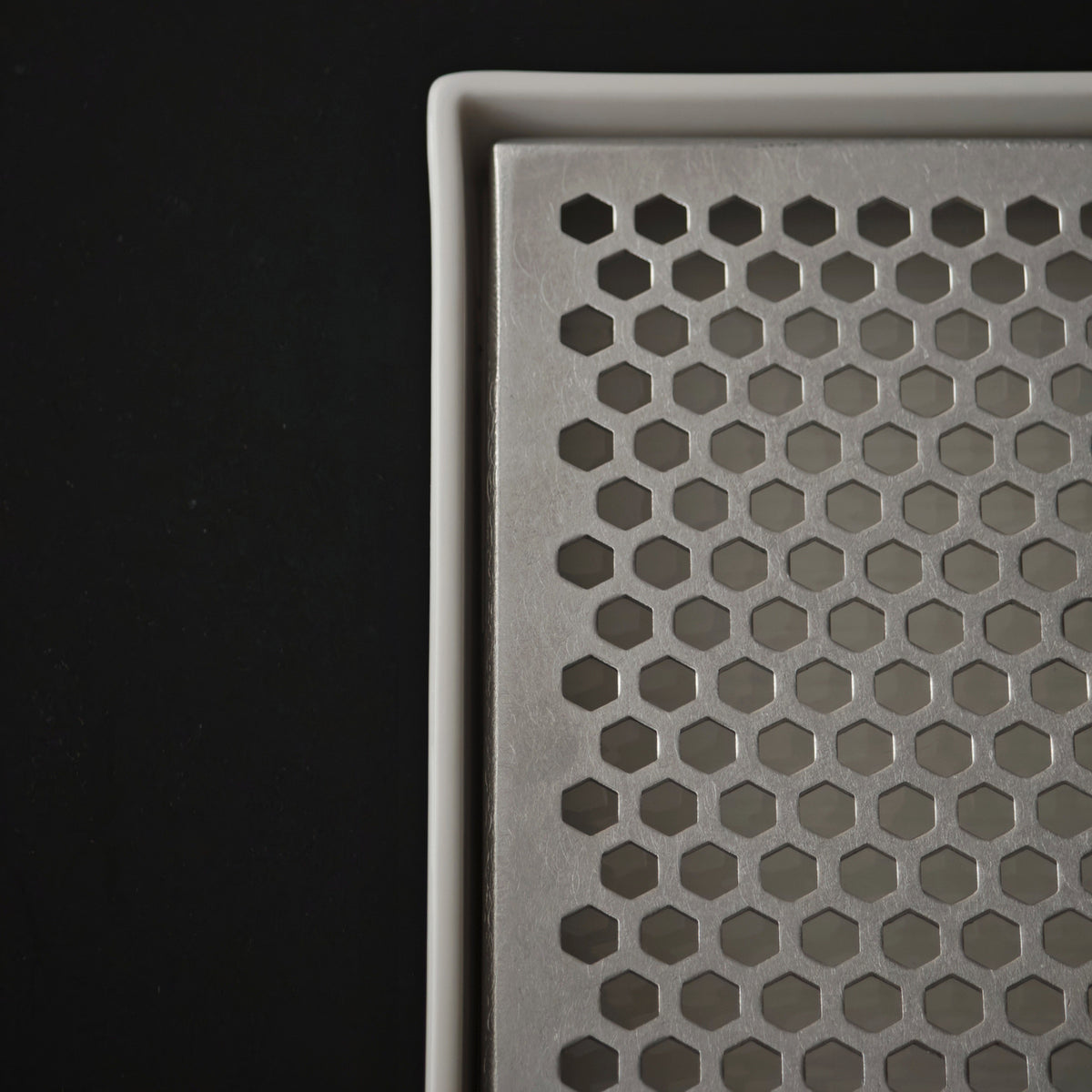 Close-up of the white porcelain rim and removable insert