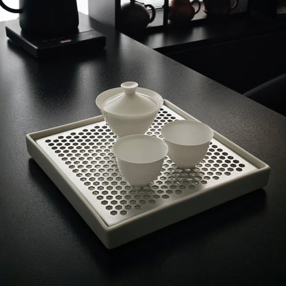 Gaiwan and teacups arranged on the white tea tray