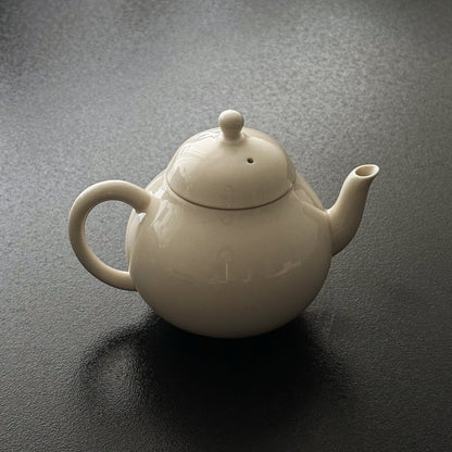 Angled view of the ceramic teapot spout and handle