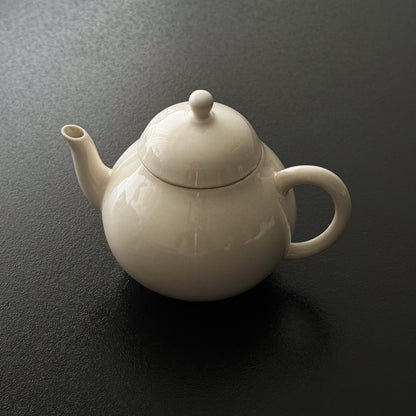 Rounded ash-glazed ceramic teapot with matching lid