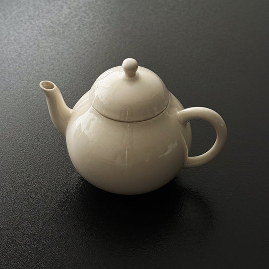 Rounded ash-glazed ceramic teapot with matching lid