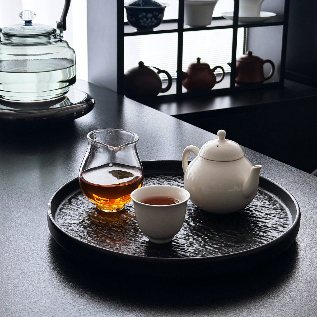 Ceramic teapot and cup in a tea table setting